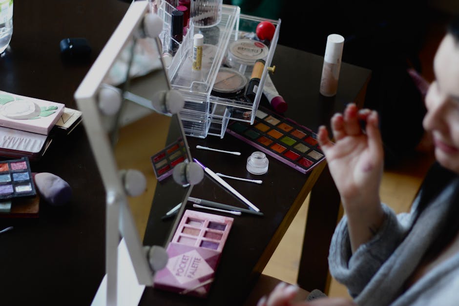 A makeup setup with various cosmetics and mirror reflection captured indoors