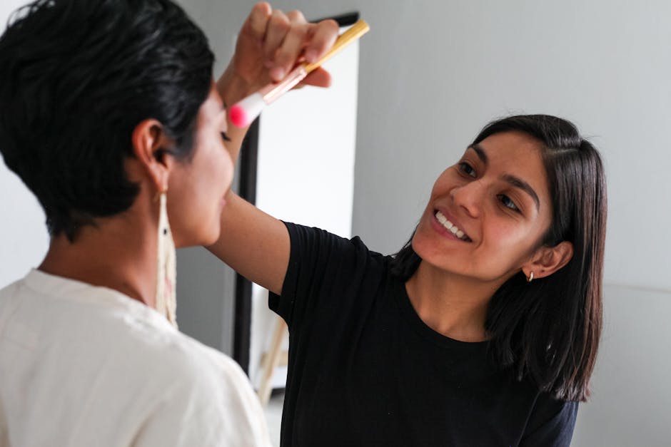 Makeup artist working on a client indoors, highlighting beauty and skill in artistry