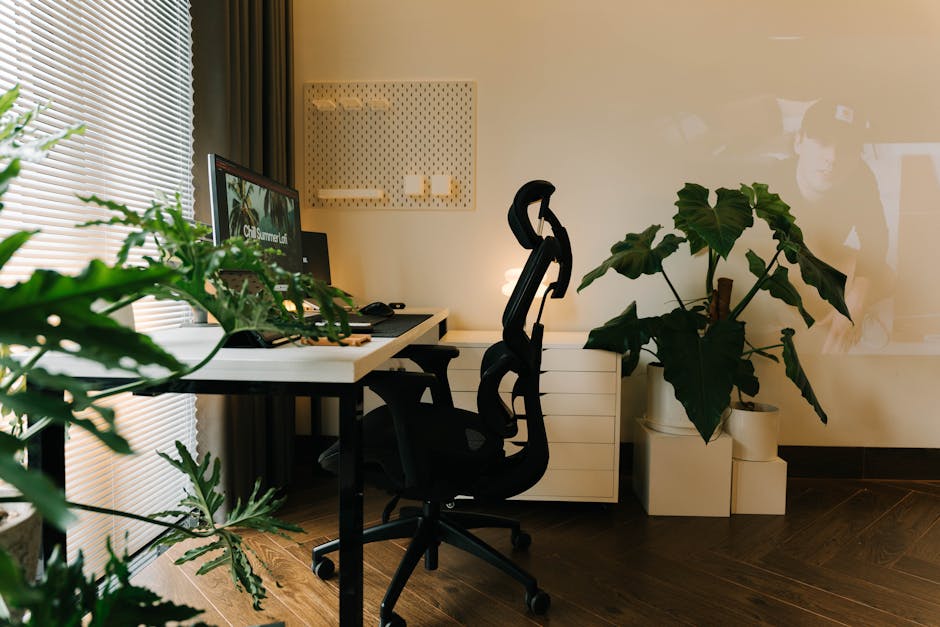 A stylish home office setup with plants and ergonomic chair.